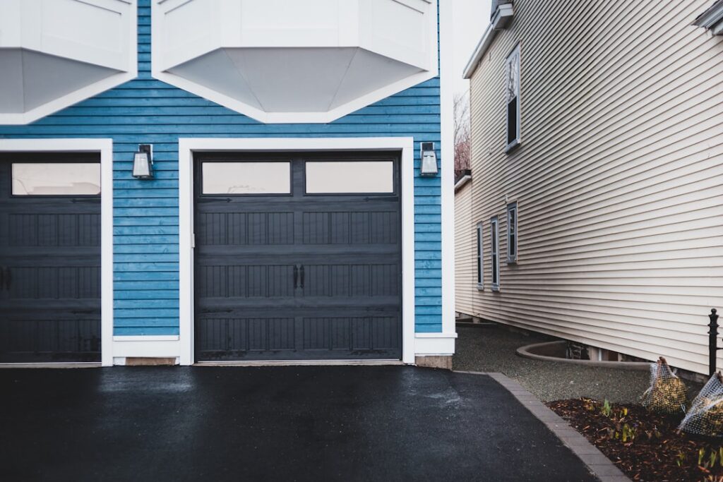 Modern blue garage with closed door for spring repair cost estimation