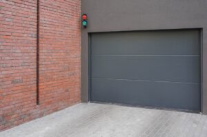 Modern garage door suitable for Australian weather, beside brick wall