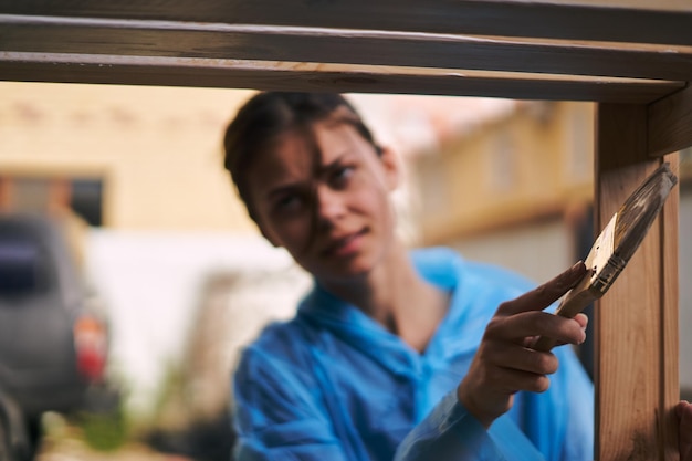 Person inspecting garage door for maintenance and repair signs